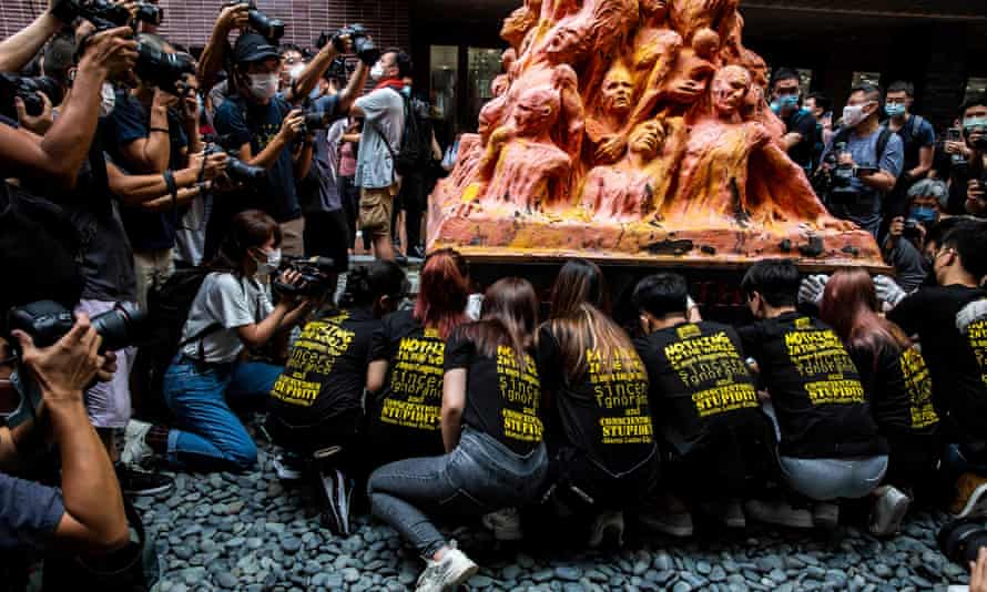 Ceremonial washing of the Pillar of Shame monument inside Hong Kong university.