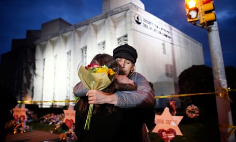 Two women hug in front of the Tree of Life Synagogue in Pittsburgh, US, where 11 people were killed in a mass shooting in October 2018. 