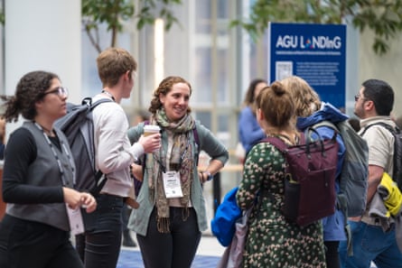 a women standing in a group of people.