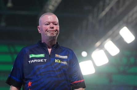 Raymond van Barneveld cuts a forlorn figure as he leaves the stage