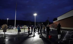 Voters line up at the Waterville Junior High School polling station before doors open in Waterville, Maine.