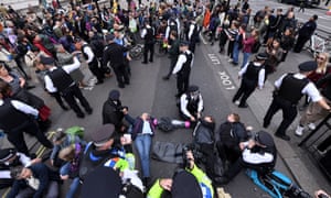 Protesters locked together stop traffic in Whitehall.