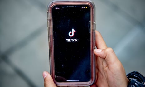 A girl uses TikTok on a phone