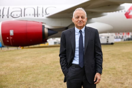 Tufan Erginbilgiç stands in front of an aeroplane