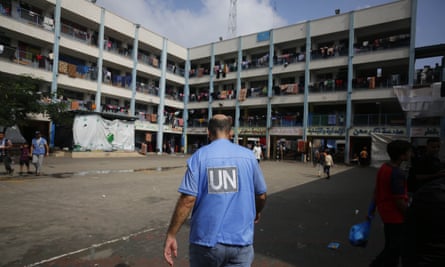UN workers distribute aid to Palestinian families taking refuge in a school in Khan Younis, Gaza.