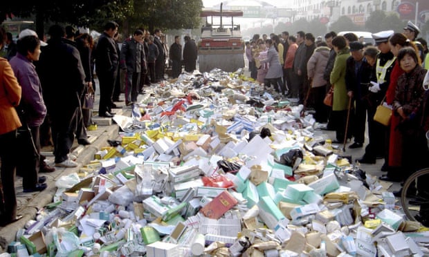 A steamroller destroys fake medicine as locals watch during a campaign against counterfeit medicine in Suqian, in east China’s Jiangsu province December 1, 2006.