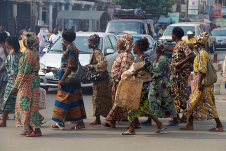 Women crossing a road in Cotonou, Benin. Photograph: Philippe Lissac/Godong/Getty Images