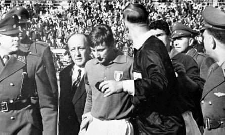 Italian forward Giorgio Ferrini, centre, is sent off by British referee Ken Aston, back to camera, after an incident during the first half of the Football World Cup match between Italy and Chile in Santiago, on June 2, 1962. Ferrini refused to leave the field after being ordered off by the referee and was removed by police officers. (AP Photo)