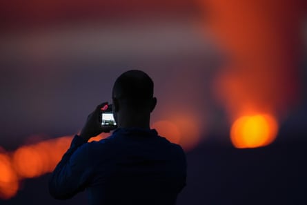 Man taking a photo of a volcano