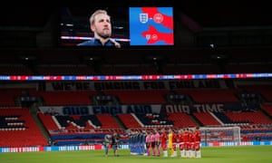 England’s Harry Kane is shown on the big screen as the players line up.