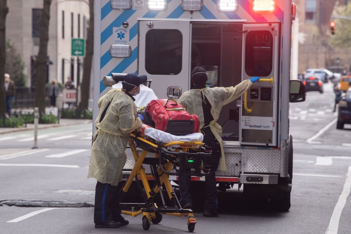 Paramedics were protective suits and face masks as they treat a patient in New York City