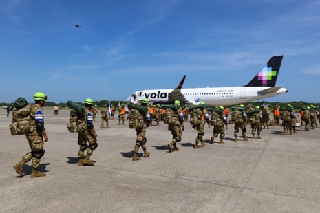 Rescue workers walk towards a plane at an airbase.