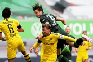 Wolfsburg’s Wout Weghorst gets above Borussia Dortmund’s Lukasz Piszczek to win a header.