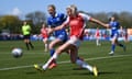 Alessia Russo of Arsenal passes the ball under pressure from Lucy Hope of Everton.
