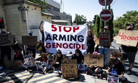 A group of Israeli and international activists gather in front of the British consulate in Jerusalem, protesting against the UK’s arms exports to Israel and holding a banner that reads ‘Stop arming genocide’