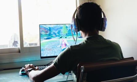 A young boy playing Fortnite on a PC