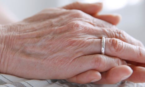 A mature woman’s hands clasped