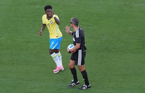 VinÃcius Júnior of Brazil questions referee Slavko Vincic as he asks for a card to be shown to a Morocco player