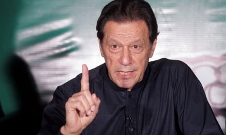 Imran Khan gestures as he speaks to the media in Lahore