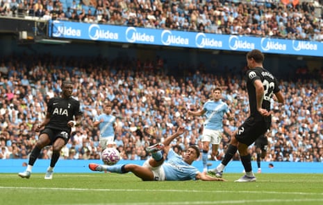 Tottenham Hotspur’s Brennan Johnson slots home to open the scoring at Manchester City.