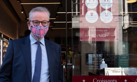 Michael Gove, chancellor of the duchy of Lancaster, leaving a coffee shop while wearing a mask.