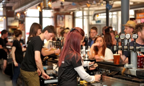 young people serving behind a bar