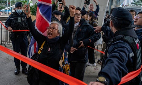 Activist Alexandra Wong holding a British flag shouts behind a police line