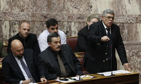 Leader of Greece’s extreme right Golden Dawn party Nikos Michaloliakos, right, speaks during a parliamentary session, in Athens, on Monday, March 30, 2015. Greece’s Prime Minister Alexis Tsipras called the special session of parliament to brief lawmakers on the course of recent troubled negotiations with bailout lenders to overhaul cost-cutting reforms. Greece is under pressure to convince creditors it has viable alternatives to the reforms, with government cash reserves running low. (AP Photo/Petros Giannakouris)