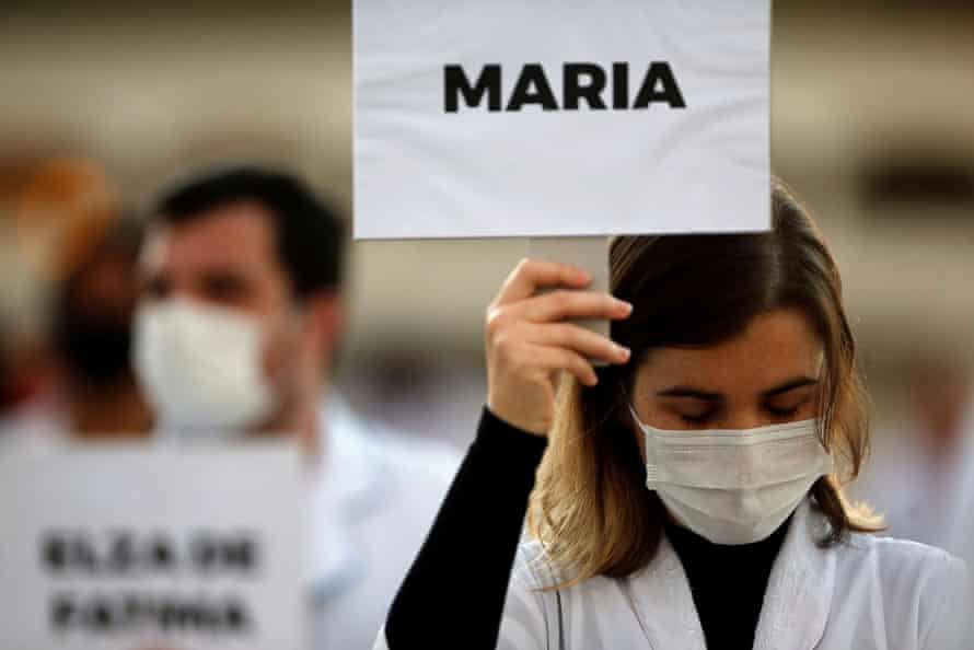 Nurses with signs bearing the names of the healthcare professionals who have died from coronavirus hold a demonstration in Brasilia.