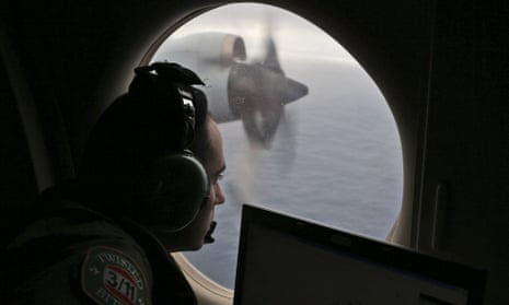 An officer from the Royal Australian Air Force scans the water in the southern Indian Ocean off Australia. The search for MH370 will go on until 2017.
