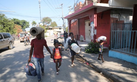 FILE PHOTO: Haiti remains in a state of emergency in the face of violence, in Port-au-Prince<br>FILE PHOTO: People fleeing from violence around their homes walk towards a shelter with their belongings, in Port-au-Prince, Haiti March 9, 2024. REUTERS/Ralph Tedy Erol/File Photo