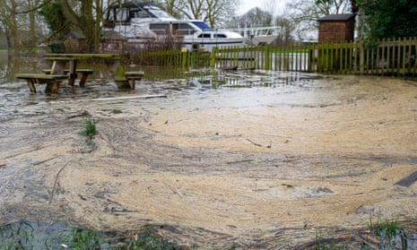 Pollution collects in a flooded picnic area by the River Thames in Datchet