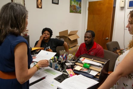 a women speaking to a man and woman