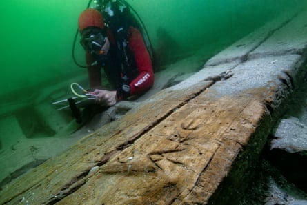 A diver next to a beam with an inscription
