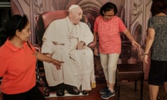 People take photos with a life-size cutout of Pope Francis at the Jakarta Cathedral in Jakarta