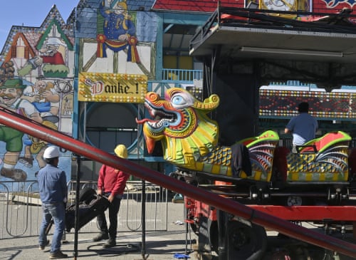 Merchants dismantle their booths in the wake of the shooting.