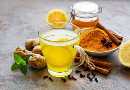 Energy tonic drink with turmeric, ginger, lemon and honey on a grey concrete background