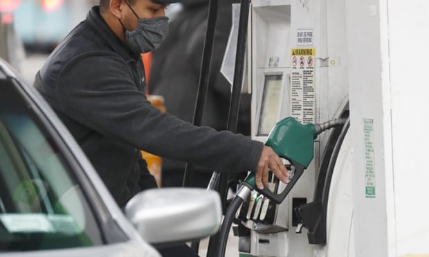 A worker at a gasoline station puts gas in the car of a customer in New York City. Americans are paying about $3.40 a gallon compared with about $2.10 a year ago.