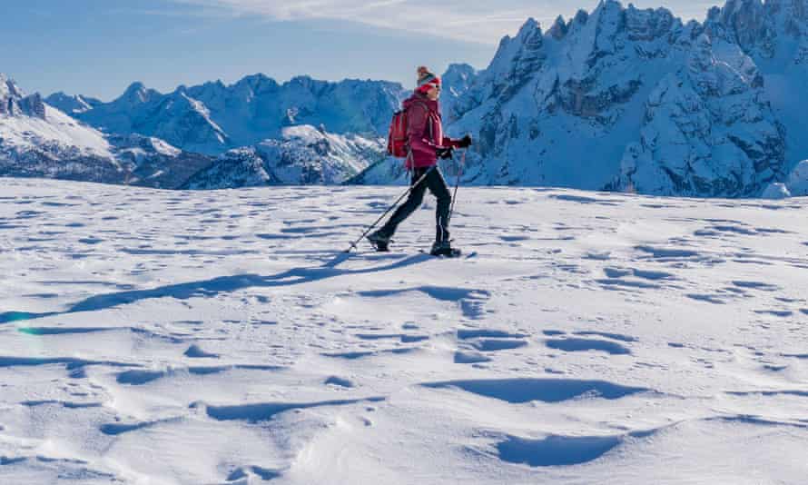 active senior woman snowshoeing from Prato Piazzo up to the Monte Specie in the three oeaks Dolomites area near village of Innichen, South Tyrol, Italy2B80FPN active senior woman snowshoeing from Prato Piazzo up to the Monte Specie in the three oeaks Dolomites area near village of Innichen, South Tyrol, Italy