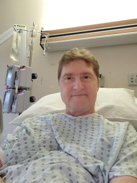 man smiles in hospital bed