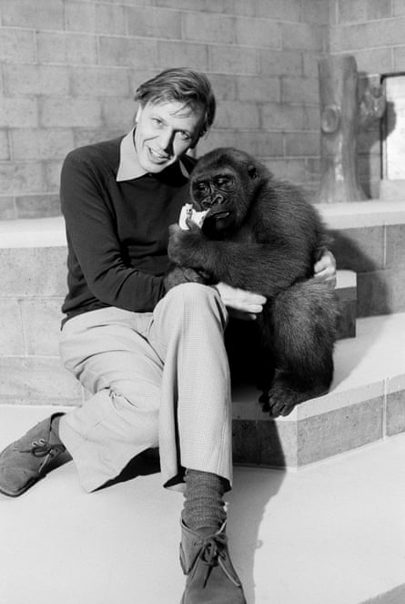Black and white photo of David Attenborough with a monkey