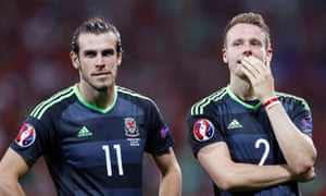 Gareth Bale contemplates defeat with Chris Gunter at the end of the match against Portugal on Wednesday.