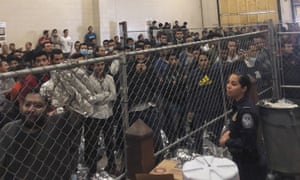 Men stand in a migrant detention center in McAllen, Texas, on Friday, Vice-President Mike Pence visits.