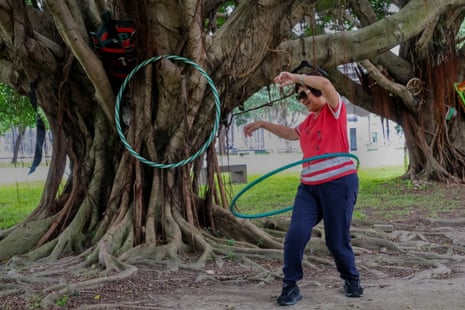 Lin Chen twirls a hula hoop around with abandon in Jiangzicui Riverside Park, November 2023