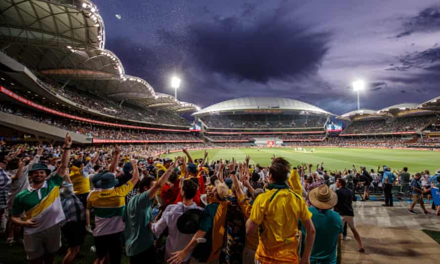 Australian fans celebrate the first wicket of the English innings.