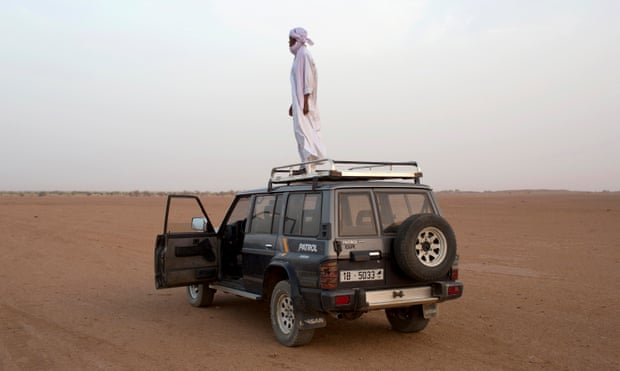 Toubou human smuggler Barka al Qatrun looks out for cars driven by his colleagues coming from Libya at a checkpoint outside Agadez.