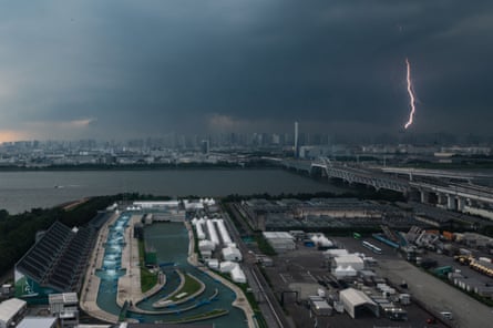 A bolt of lightning is seen in the background past the Kasai canoe slalom centre in Tokyo.