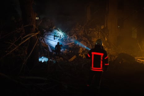 A rescuer shines a flashlight during hunt and rescue operations successful Kramatorsk.