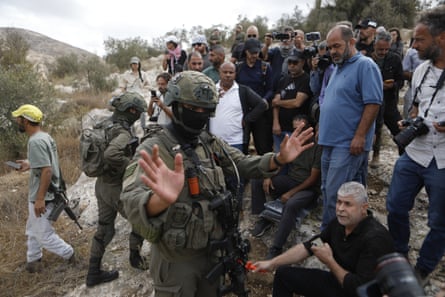 Israeli settlers, backed by army forces, attack a group of Palestinian and international activists taking part in an olive-harvesting, Hebron, West Bank, 12 Oct 2025