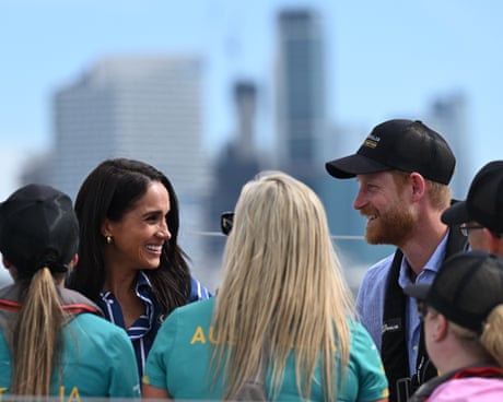 Prince Harry and Meghan, the Duke and Duchess of Sussex converse while on a tour of Sydney Harbour with Invictus Australia